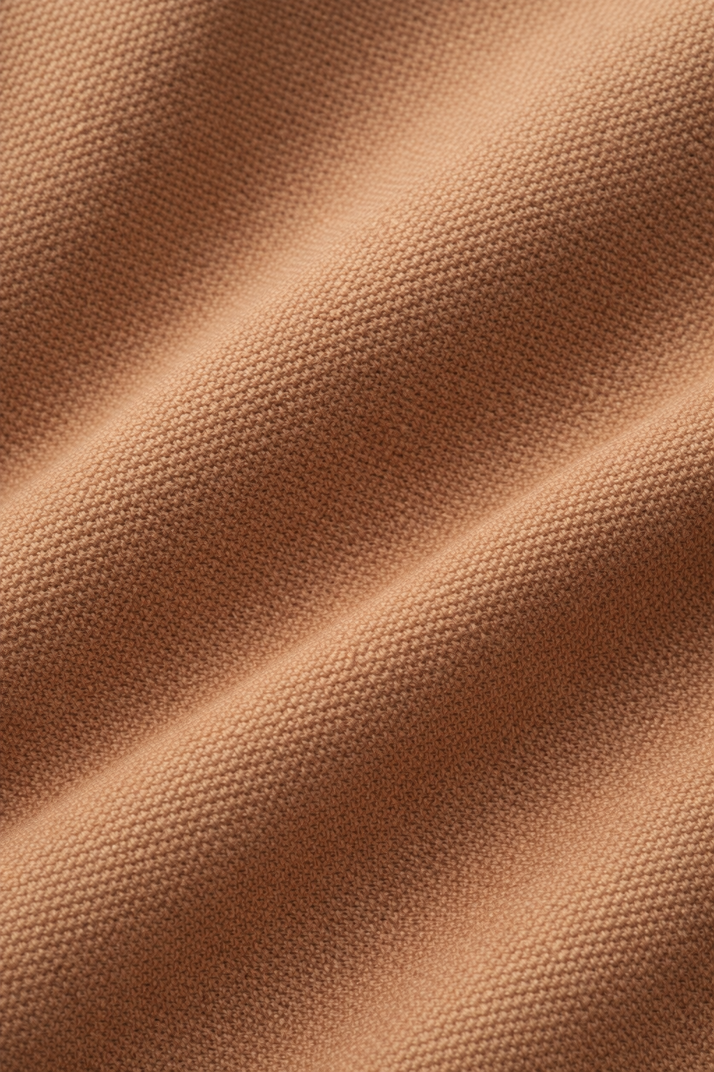 Detailfoto van de stof van de winterjas in bruin